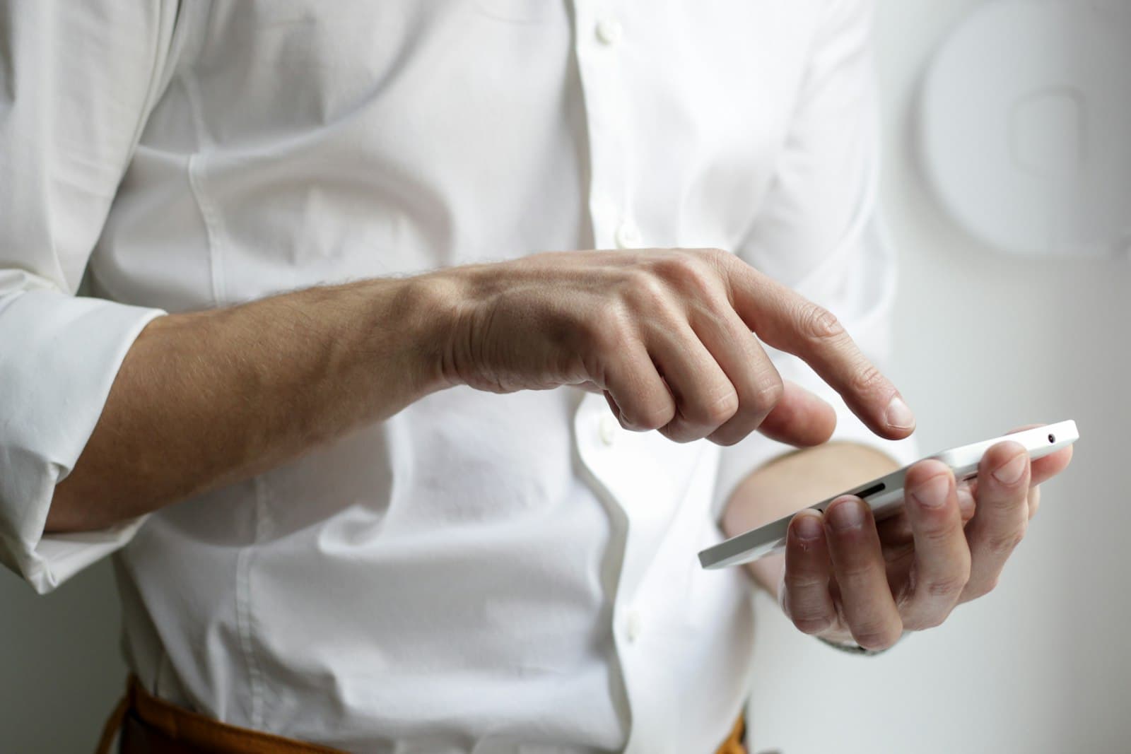 Person holding a smartphone and tapping the screen