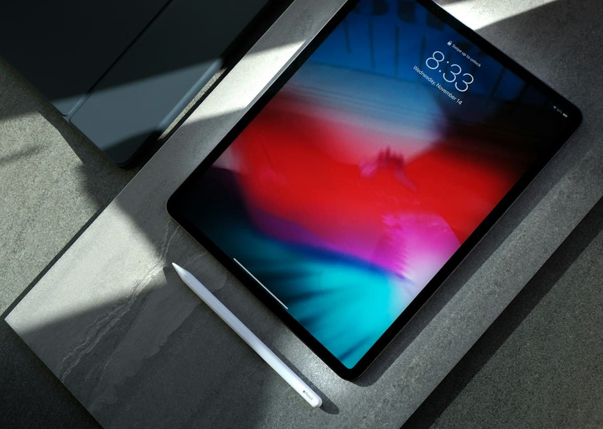 Tablet with a colourful screen resting on a dark surface