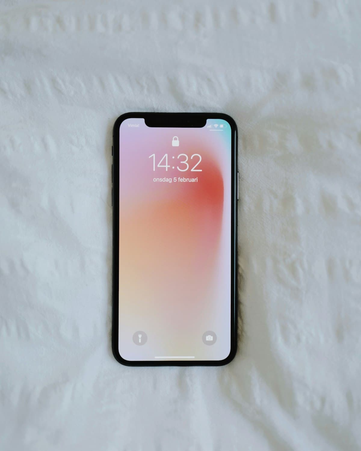 Smartphone lying on a white textured surface